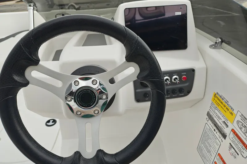 Slide: The Image of Steering wheel and dashboard of 2027 Tahoe T16 boat with control panel. - 11