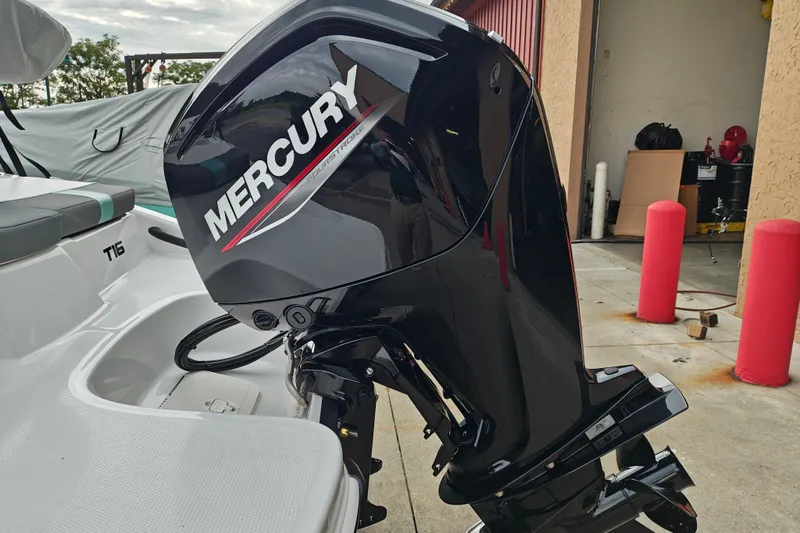 Slide: The Image of 2027 Tahoe T16 boat with Mercury outboard motor in a garage setting. - 6