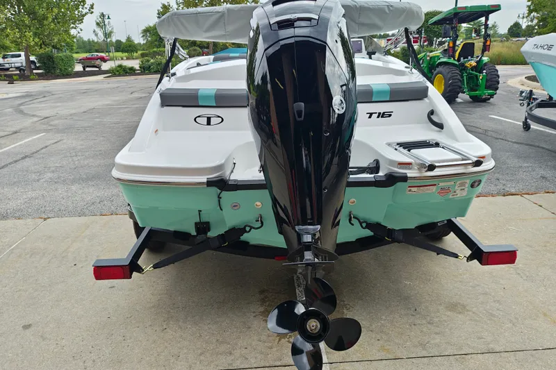 Slide: The Image of 2027 Tahoe T16 boat with outboard motor, parked on a concrete surface. - 5
