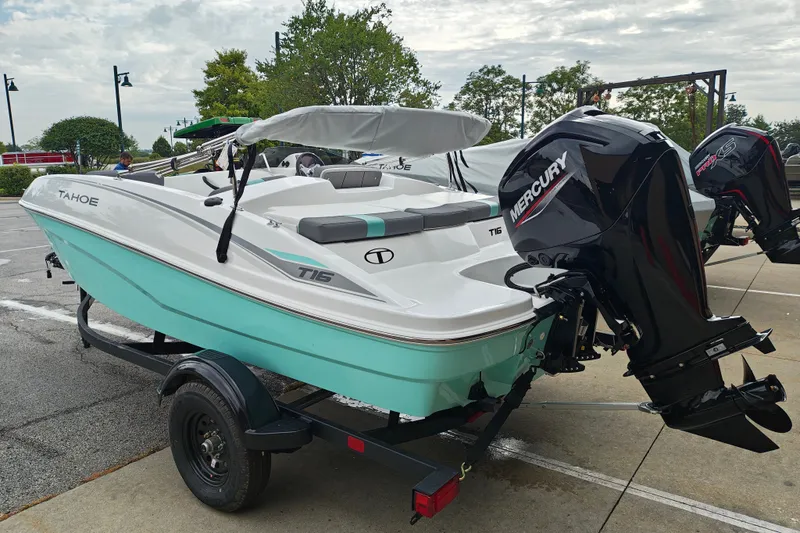 Slide: The Image of 2027 Tahoe T16 boat with Mercury engine on a trailer, parked outdoors. - 4