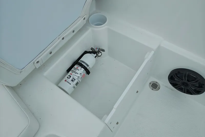 Slide: The Image of Storage compartment in 2027 Tahoe T16 boat with fire extinguisher and speaker. - 16