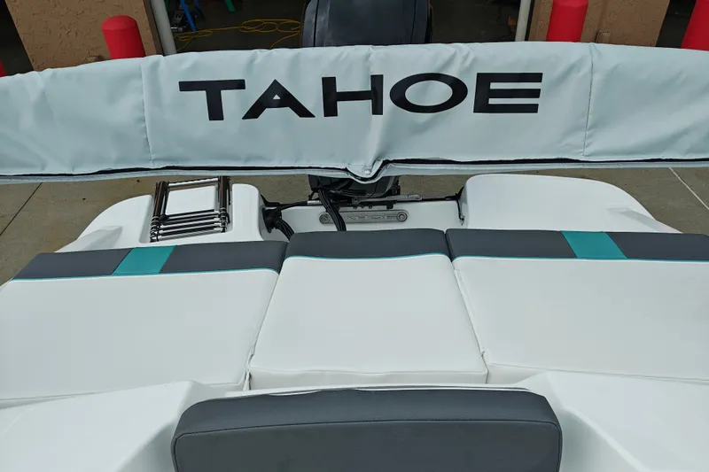 Slide: The Image of 2027 Tahoe T16 boat with cushioned seating and ladder, showcasing sleek design. - 20