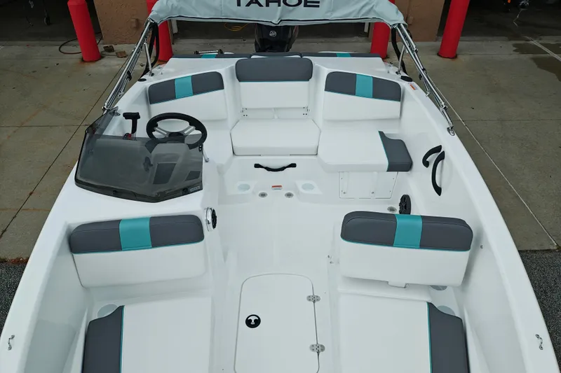 Slide: The Image of 2027 Tahoe T16 boat interior with gray and teal seating, steering wheel, and windshield. - 8