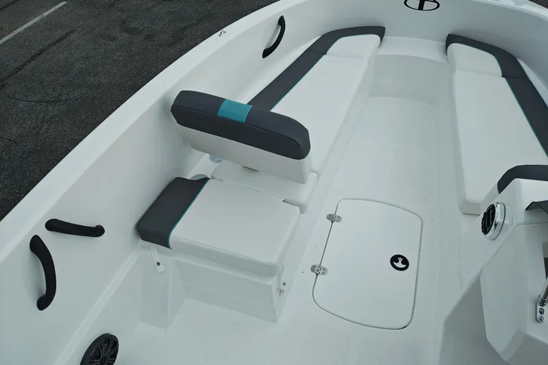Slide: The Image of 2027 Tahoe T16 boat interior with white and gray seating, storage hatch, and sleek design. - 23