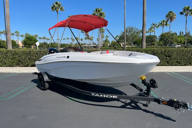 Slide: The Image of 2027 Tahoe T18 boat with red canopy on trailer in sunny parking lot. - 3