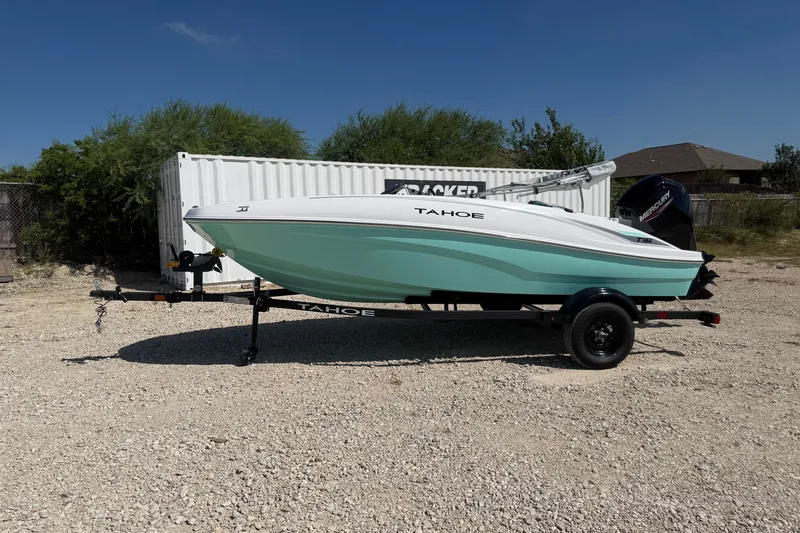 The Image of 2027 Tahoe T16 boat on trailer, parked outdoors under clear blue sky. - 0