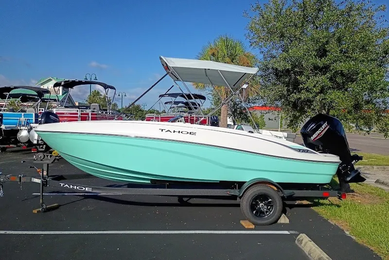 Slide: The Image of 2027 Tahoe T18 boat with canopy on trailer in parking lot. - 1