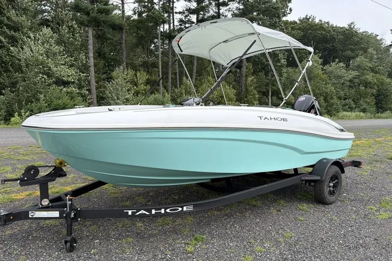 Slide: The Image of 2027 Tahoe T18 boat on trailer, light blue hull, parked outdoors. - 1