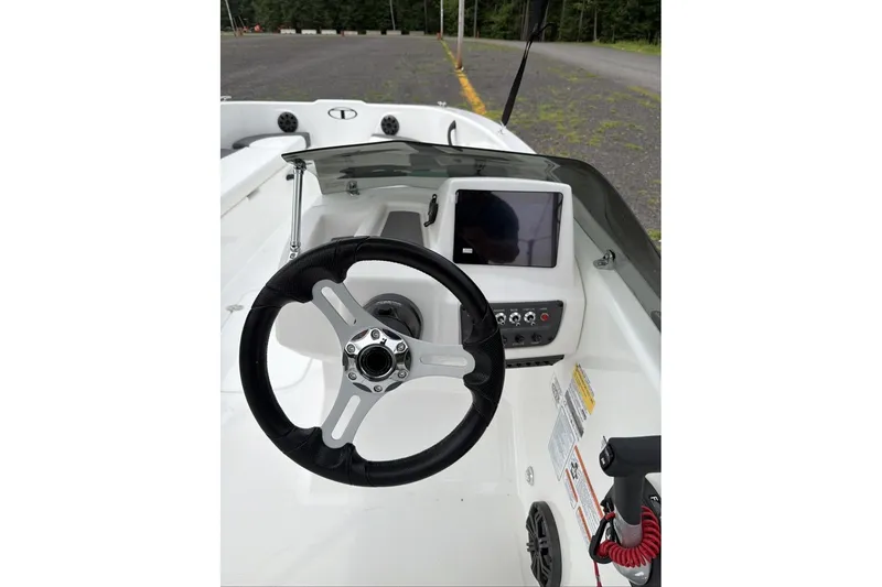 Slide: The Image of 2027 Tahoe T18 boat dashboard with steering wheel and control panel. - 9