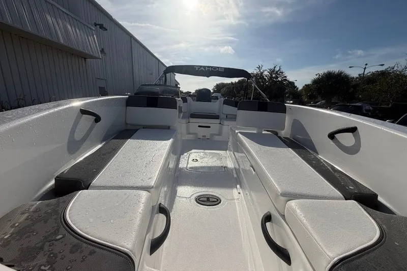 Slide: The Image of 2027 Tahoe T18 boat interior with sleek seating and modern design under sunny skies. - 6