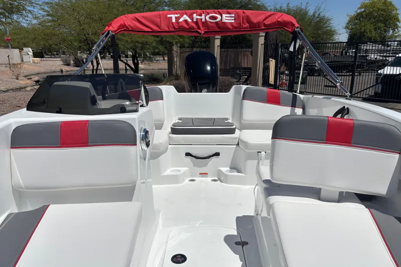 Slide: The Image of 2027 Tahoe T16 boat interior with red and gray seating, under a sunny sky. - 12