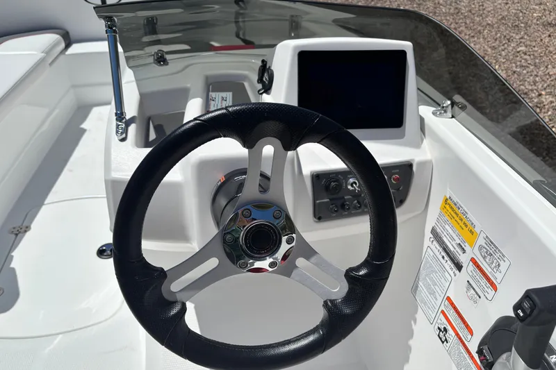 Slide: The Image of Steering console of a 2027 Tahoe T16 boat with modern controls and display. - 16