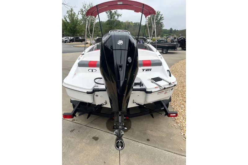 Slide: The Image of 2027 Tahoe T21 boat with outboard motor, parked on a concrete surface. - 3