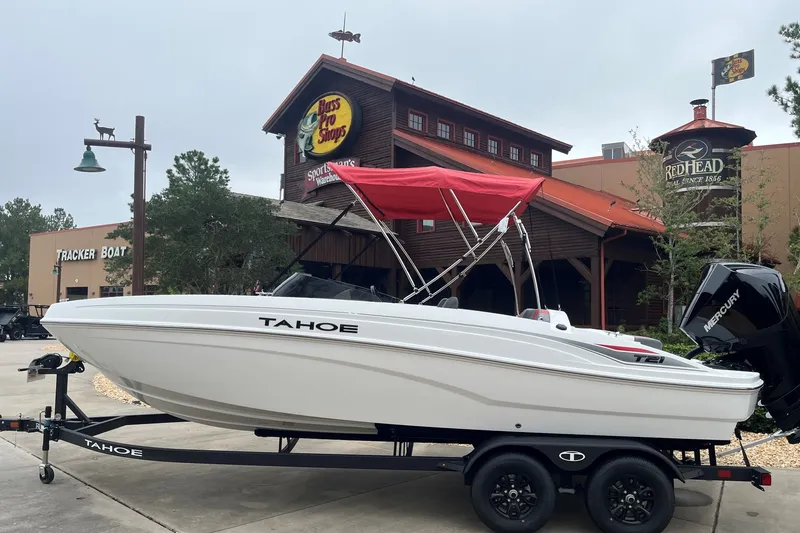 The Image of 2027 Tahoe T21 boat with red canopy on trailer outside Bass Pro Shops. - 0