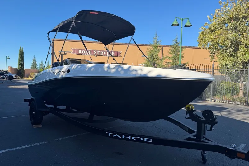 Slide: The Image of 2027 Tahoe T18 boat on trailer at boat service center, sunny day. - 3