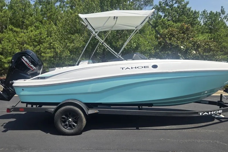 The Image of 2027 Tahoe T18 boat with canopy on trailer, parked outdoors. - 0