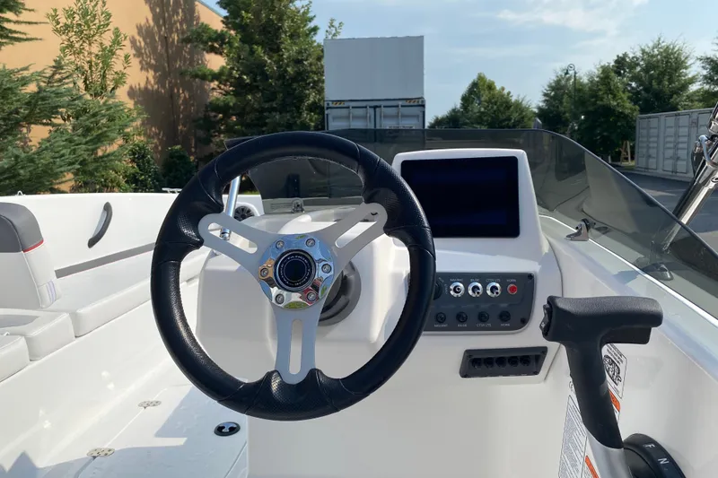 Slide: The Image of Steering wheel and dashboard of 2027 Tahoe T18 boat, featuring modern controls and display. - 4