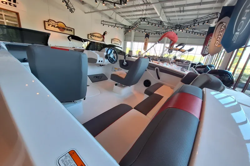 Slide: The Image of Interior of a 2027 Tahoe T21 boat in a showroom, featuring modern seating and design. - 93
