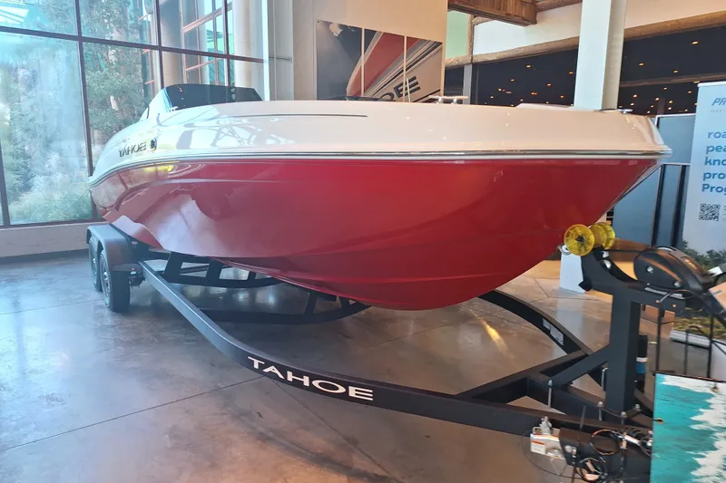 The Image of 2027 Tahoe T21 boat with red hull on display indoors. - 0