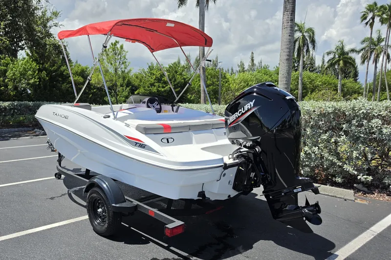 Slide: The Image of 2027 Tahoe T16 boat with red canopy and Mercury outboard motor in a parking lot. - 71