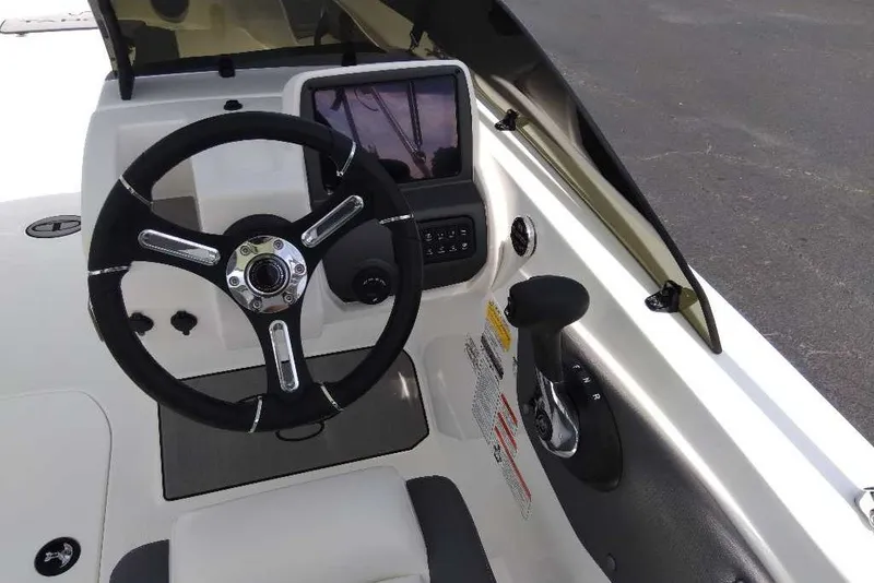 Slide: The Image of Steering console of 2027 Tahoe T21 boat with modern controls and display. - 6