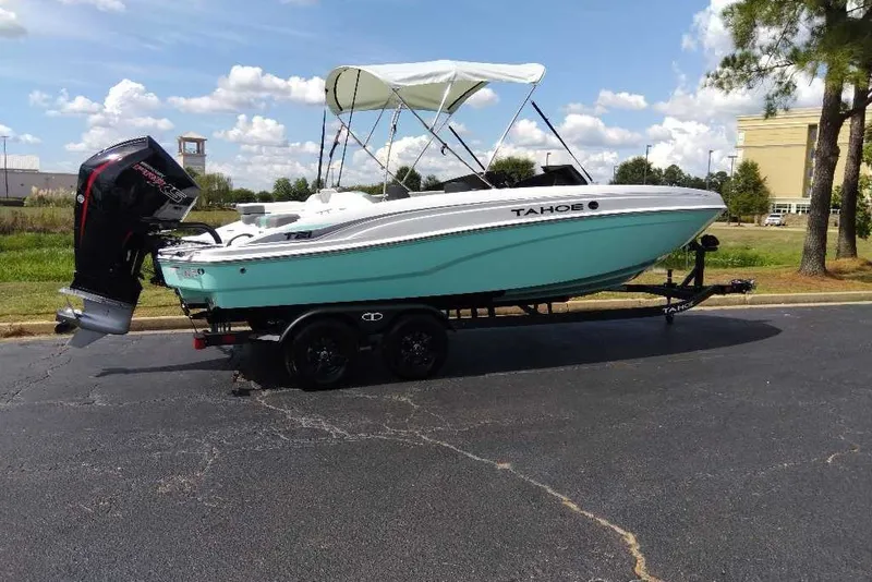 The Image of 2027 Tahoe T21 boat on trailer, parked outdoors under a clear sky. - 0
