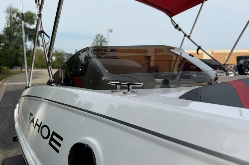 Slide: The Image of 2027 Tahoe T18 boat with sleek design and modern features, docked outdoors. - 14