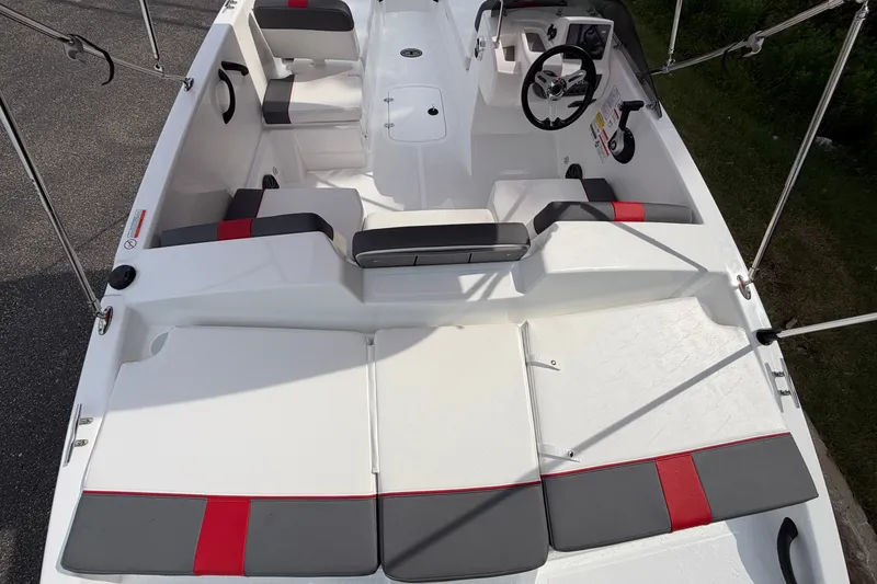 Slide: The Image of 2027 Tahoe T18 boat interior with modern seating and steering wheel, featuring red and gray accents. - 9