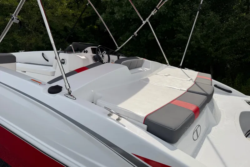 Slide: The Image of 2027 Tahoe T18 boat with sleek seating and modern design, set against a lush green backdrop. - 10