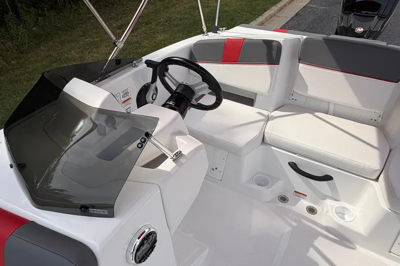 Slide: The Image of 2027 Tahoe T18 boat interior with steering wheel, cushioned seating, and modern design. - 22