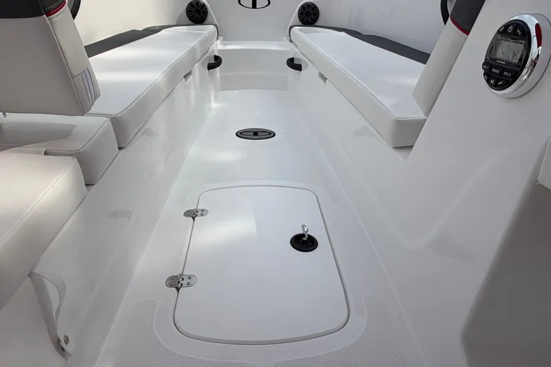 Slide: The Image of Interior of 2027 Tahoe T18 boat with white seating and storage compartments. - 18