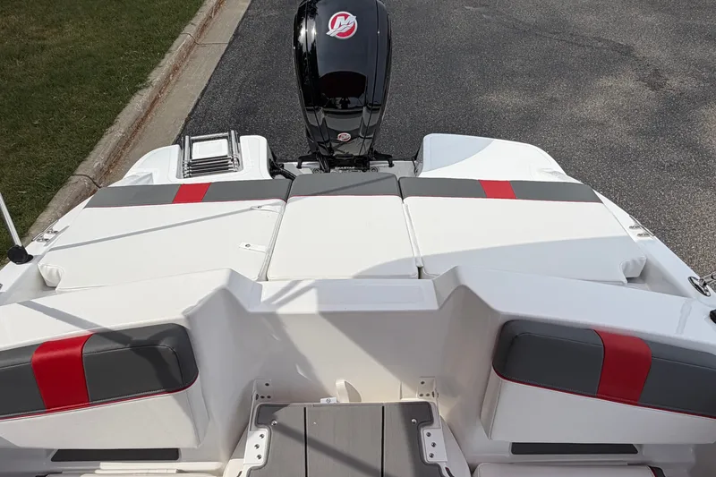 Slide: The Image of 2027 Tahoe T18 boat with sleek design, featuring red and gray accents on white seating. - 8