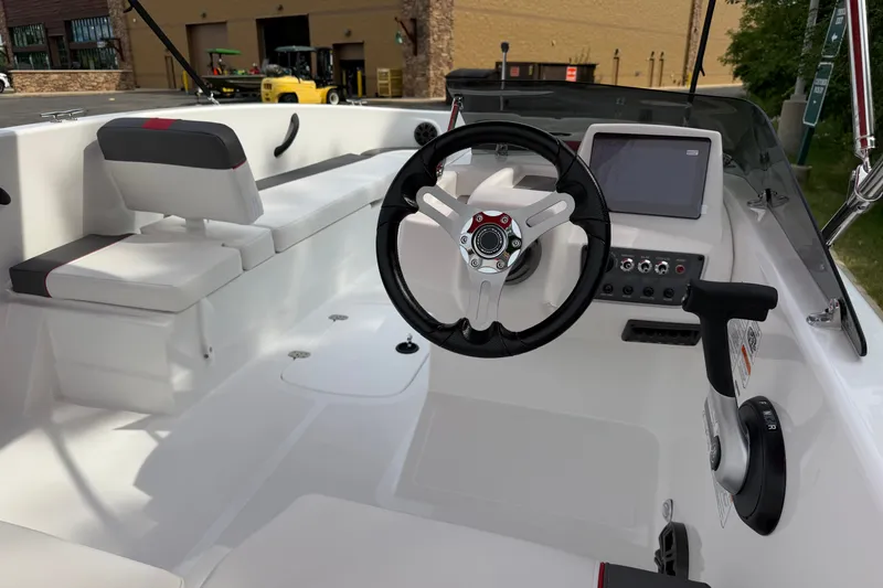 Slide: The Image of Interior of a 2027 Tahoe T18 boat featuring steering wheel and control panel. - 16