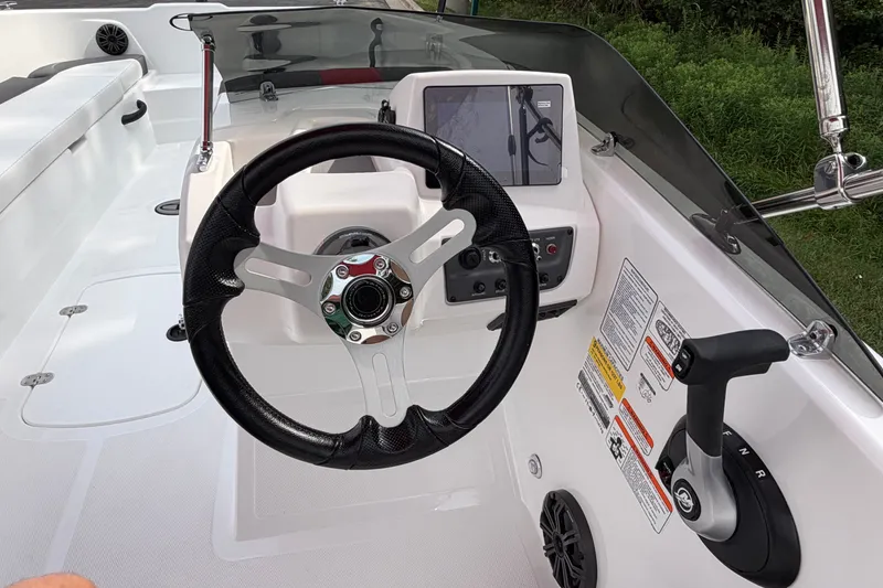 Slide: The Image of Steering console of a 2027 Tahoe T18 boat with modern controls and display. - 17