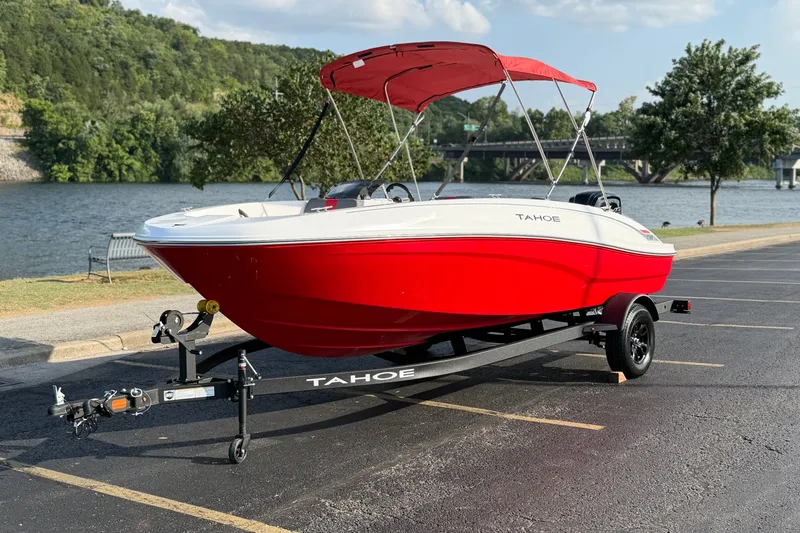 Slide: The Image of Red 2027 Tahoe T18 boat on trailer by a scenic riverside parking lot. - 3