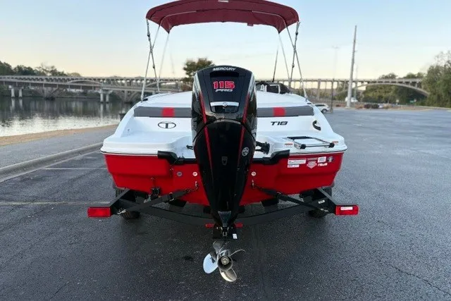 Slide: The Image of 2027 Tahoe T18 boat with Mercury engine, parked near a scenic waterfront. - 91