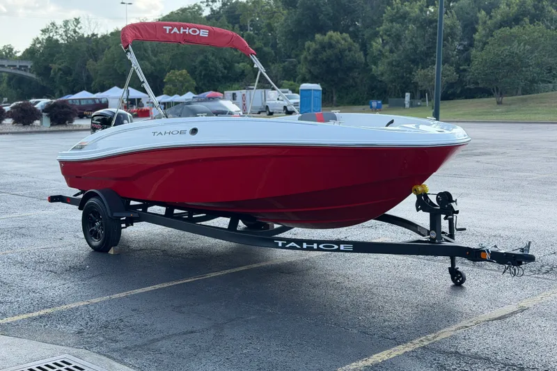 Slide: The Image of 2027 Tahoe T18 boat on trailer, red and white design, parked outdoors. - 9