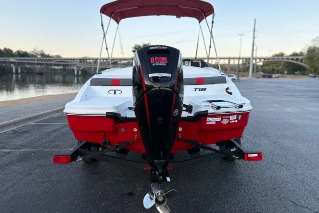 Slide: The Image of 2027 Tahoe T18 boat with Mercury 115 Pro XS engine, parked near a waterfront. - 12