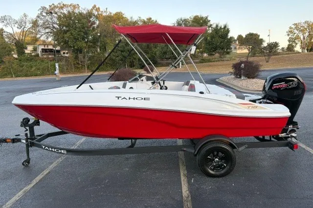 Slide: The Image of 2027 Tahoe T18 boat with red hull and canopy on a trailer in a parking lot. - 5