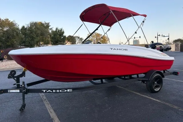 Slide: The Image of 2027 Tahoe T18 boat with red hull and canopy on trailer in parking lot. - 3