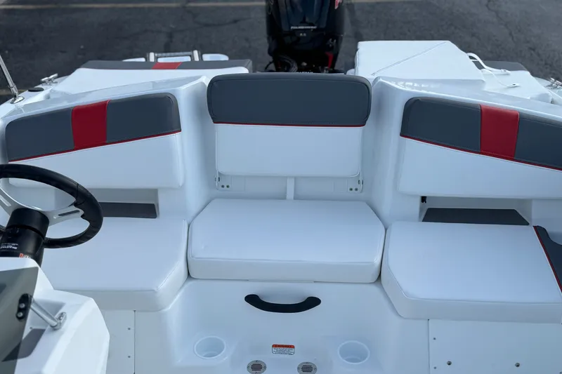 Slide: The Image of 2027 Tahoe T18 boat interior with white and gray seating, red accents, and steering wheel. - 19