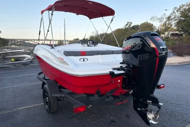 Slide: The Image of Red and white 2027 Tahoe T18 boat with outboard motor on trailer. - 13