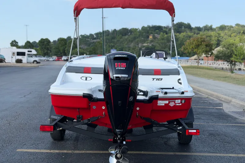 Slide: The Image of 2027 Tahoe T18 boat with Mercury 115 engine, parked on a paved lot. - 5