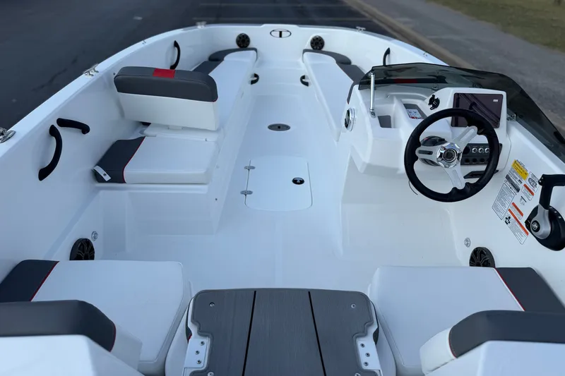 Slide: The Image of 2027 Tahoe T18 boat interior with modern seating and steering console. - 14