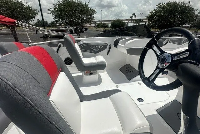 Slide: The Image of 2027 Tahoe T21 boat interior with modern steering and seating, featuring red and gray accents. - 6