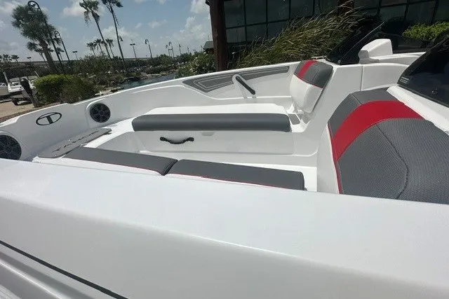 Slide: The Image of 2027 Tahoe T21 boat interior with gray and red seating, outdoor setting. - 12