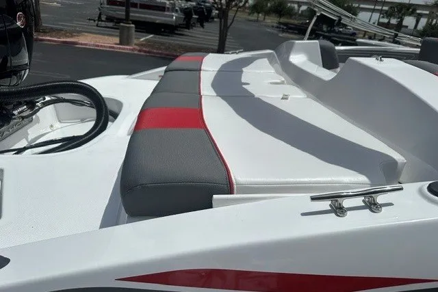 Slide: The Image of 2027 Tahoe T21 boat with red and gray seating, docked in a parking area. - 9