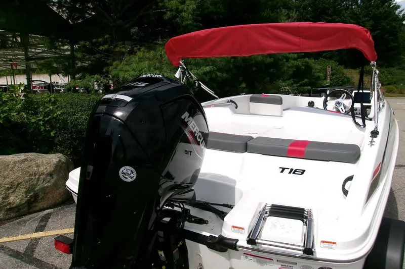 Slide: The Image of 2027 Tahoe T18 boat with red canopy and Mercury outboard motor. - 2