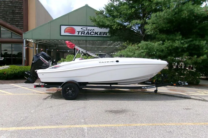 Slide: The Image of 2027 Tahoe T18 boat on trailer outside Sun Tracker dealership. - 1