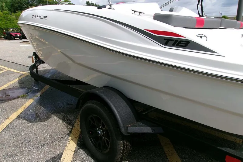 Slide: The Image of 2027 Tahoe T18 boat on trailer in parking lot, side view. - 4